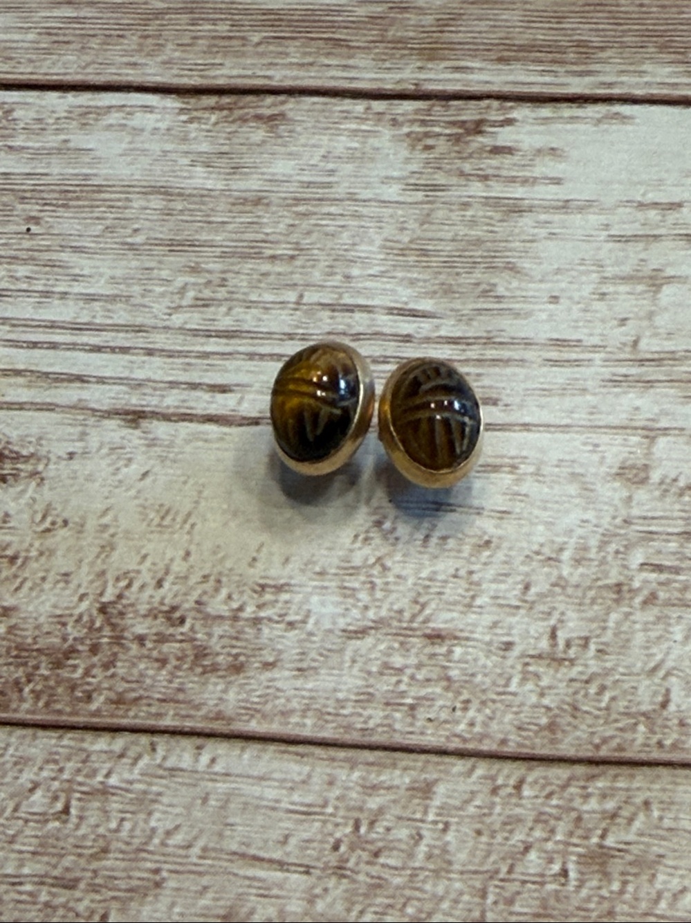 Vintage tiger's eye stones carved into a scarab design and set in gold
